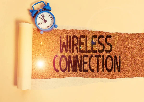 Writing note showing Wireless Connection. Business photo showcasing there is no physical wired connection between networks Alarm clock and torn cardboard on a wooden classic table backdrop. — Stock Photo, Image