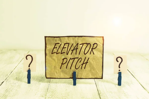 Writing note showing Elevator Pitch. Business photo showcasing the elevator statement is a short description of an idea Crumbling sheet with paper clips placed on the wooden table. — 图库照片