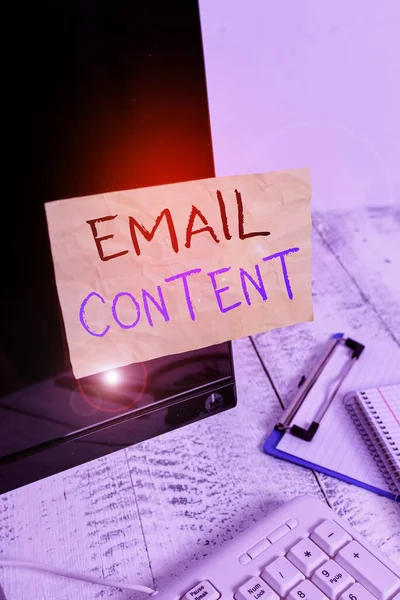 Conceptual hand writing showing Email Content. Business photo showcasing It is the essence of a communicated message or discourse Note paper taped to black screen near keyboard stationary.