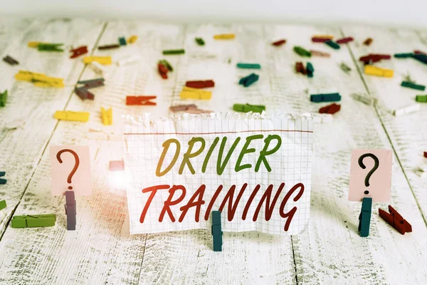 Writing note showing Driver Training. Business photo showcasing course of study that teaches how to drive a vehicle Crumbling sheet with paper clips placed on the wooden table.