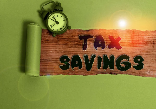 Handwriting text Tax Savings. Concept meaning only a portion of income is taxable Pay a reduced amount of tax.