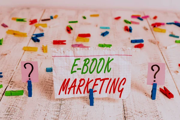 Writing note showing E Book Marketing. Business photo showcasing digital file that can be used on any compatible computer Crumbling sheet with paper clips placed on the wooden table. — Stock Photo, Image