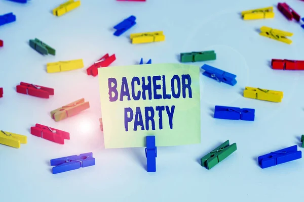 Word writing text Bachelor Party. Business concept for a party given for a analysis who is about to get married Colored clothespin papers empty reminder white floor background office.