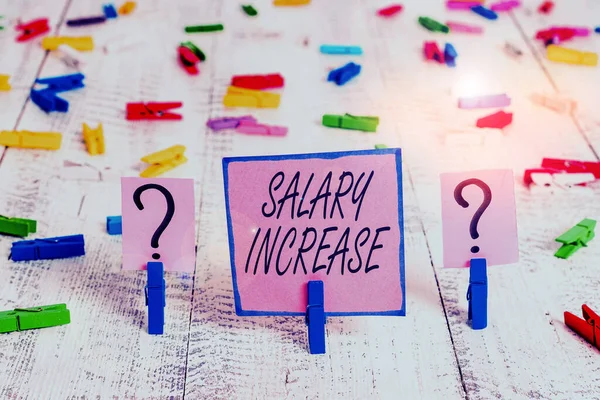 Text sign showing Salary Increase. Conceptual photo an increase in the salary or pay given to an employee Scribbled and crumbling sheet with paper clips placed on the wooden table.