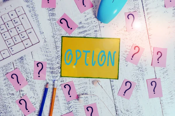 Text sign showing Option. Conceptual photo the opportunity or ability to choose something or to choose Writing tools, computer stuff and scribbled paper on top of wooden table.