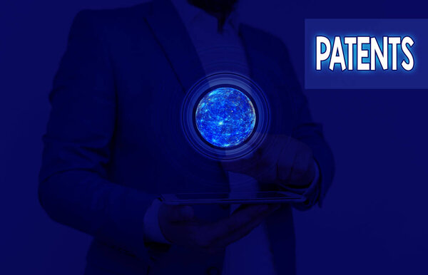 Writing note showing Patents. Business photo showcasing government authority or licence conferring a right or title Elements of this image furnished by NASA.