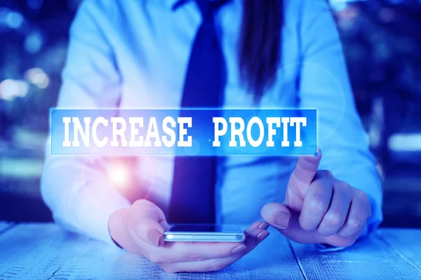 Handwriting text Increase Profit. Concept meaning amount of revenue gained from a business activity exceeds Female business person sitting by table and holding mobile phone. — Stock Photo, Image