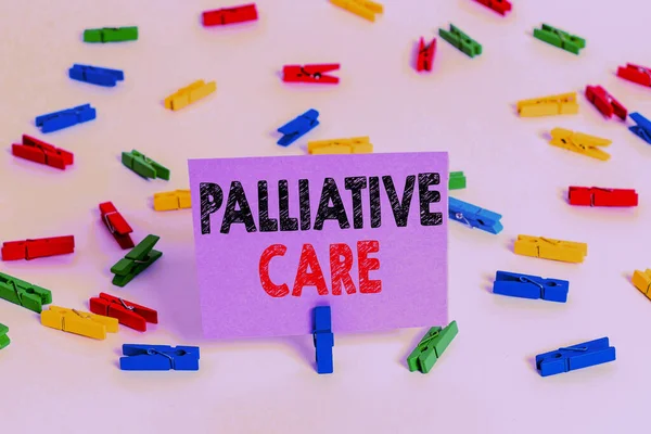 Word writing text Palliative Care. Business concept for specialized medical care for showing with a serious illness Colored clothespin papers empty reminder white floor background office.