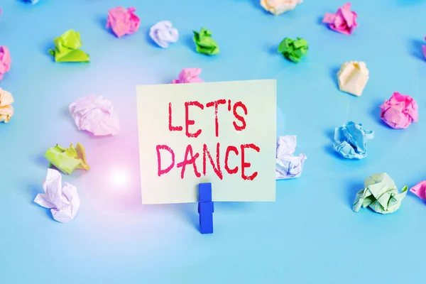 Word writing text Let S Is Dance. Business concept for move rhythmically to music following a set sequence of steps Colored crumpled papers empty reminder blue floor background clothespin.