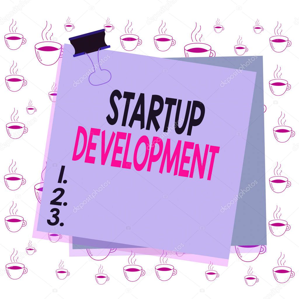 Writing note showing Startup Development. Business photo showcasing efficiently develop and validate scalable business model Paper stuck binder clip colorful background reminder memo office supply.