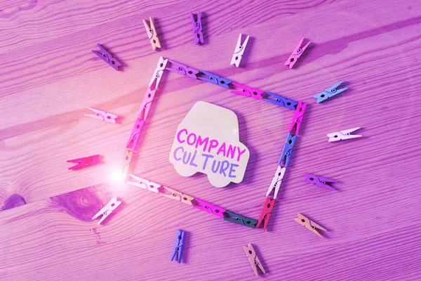 Text sign showing Company Culture. Conceptual photo pervasive values and attitudes that characterize a company Colored clothespin papers empty reminder wooden floor background office.
