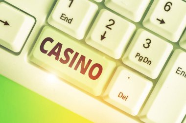 Kumarhaneyi gösteren kavramsal el yazısı. Oyunların özellikle rulet ve kart oyunlarının oynandığı bir binanın iş fotoğrafı sergileniyor.