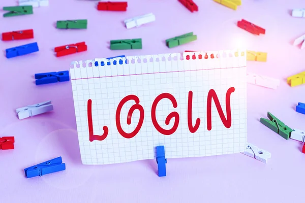 Handwriting text Login. Concept meaning Entering website Blog using username and password Registration Colored clothespin papers empty reminder pink floor background office pin.