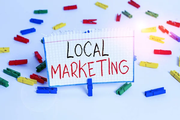 Text sign showing Local Marketing. Conceptual photo targets customers by finely grained location such as a city Colored clothespin papers empty reminder white floor background office.