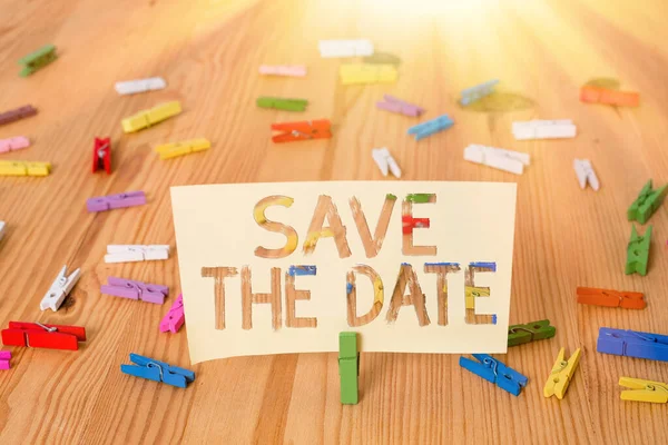 Text sign showing Save The Date. Conceptual photo Organizing events well make day special event organizers Colored clothespin papers empty reminder wooden floor background office. — Stock Photo, Image