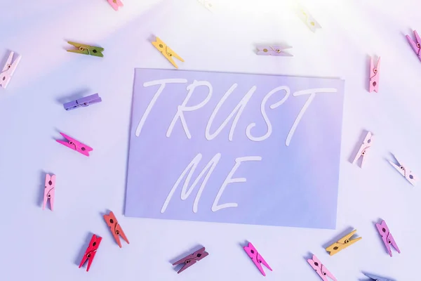 Text sign showing Trust Me. Conceptual photo Believe Have faith in other demonstrating Offer support assistance Colored clothespin rectangle shaped reminder paper light blue background.