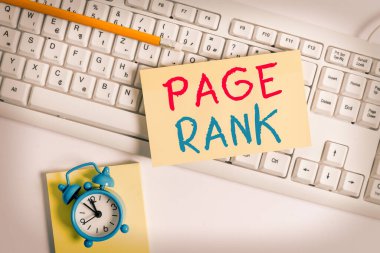 Sayfa Rütbesini gösteren bir not yazıyorum. Popülaritesinin bir ölçüsü olarak bir web sayfasına verilen bir değeri gösteren iş fotoğrafı pc klavye kalemleri ve saat üzerindeki boş not kağıdının üzerinde yatıyordu.