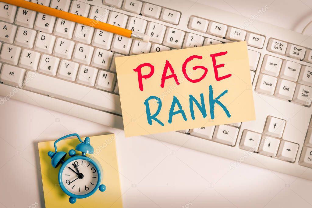 Writing note showing Page Rank. Business photo showcasing a value assigned to a web page as a measure of its popularity Flat lay above empty note paper on the pc keyboard pencils and clock.