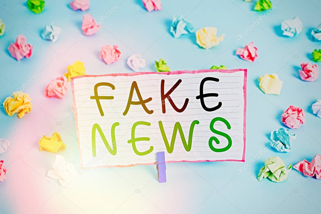 Conceptual hand writing showing Fake News. Business photo text false information publish under the guise of being authentic news Colored crumpled papers empty reminder blue floor clothespin.