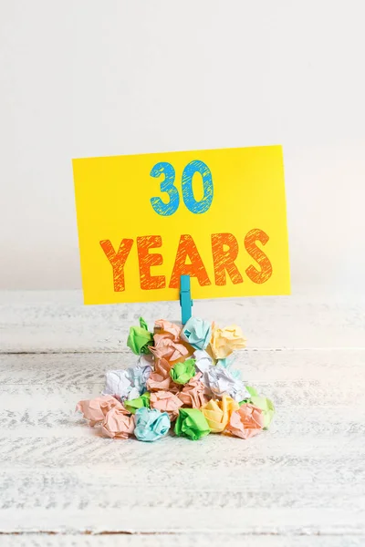 Texto de caligrafia 30 anos. Conceito significado Lembrando ou honrando dia especial por ser 30 anos de existência Lembrete pilha colorido papel enrugado pano lembrete espaço em madeira branca . — Fotografia de Stock