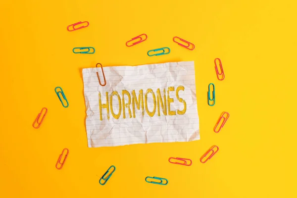 Handwriting text Hormones. Concept meaning regulatory substance produced in organism transported tissue fluids Blank crushed paper sheet message clips binders plain colored background. — Stock Photo, Image