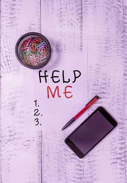 Text sign showing Help Me. Conceptual photo Asking someone to assist you Shouting for it Teamwork Volunteer Smartphone paper sheet clips holder ballpoint wooden vintage background.