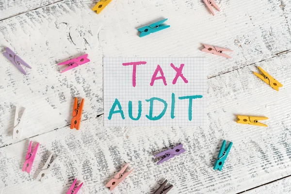 Text sign showing Tax Audit. Conceptual photo examination or verification of a business or individual tax return Colored clothespin rectangle square shaped paper white wood background.