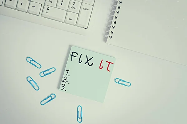Text sign showing Fix It. Conceptual photo Fasten something securely in a particular place or position To repair Empty note paper on the white background by the pc keyboard with copy space.