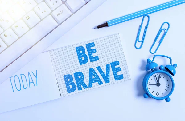 Schrijfbriefje met Be Brave. Zakelijke foto showcasing klaar om te worden geconfronteerd en te verdragen gevaar of pijn tonen moed vet wit pc toetsenbord met papier en paperclip boven witte achtergrond. — Stockfoto