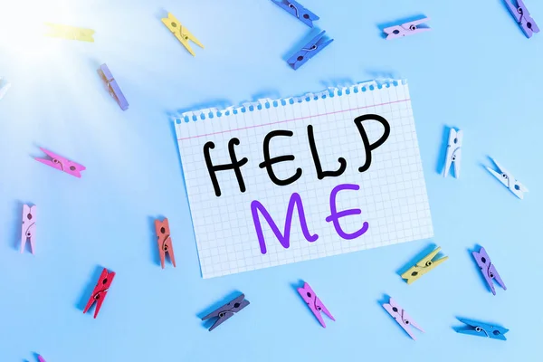 Writing note showing Help Me. Business photo showcasing Asking someone to assist you Shouting for it Teamwork Volunteer Colored clothespin rectangle shaped paper blue background.