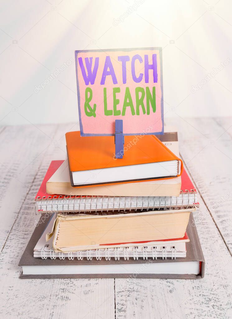 Writing note showing Watch And Learn. Business photo showcasing demonstrating an action or ideas of how to do things pile stacked books notebook pin color reminder white wooden.