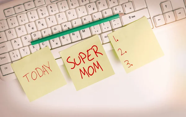 Text sign showing Super Mom. Conceptual photo a mother who can combine childcare and fulltime employment Three empty green square papers and pencil by the pc keyboard with copy space. — Stock Photo, Image