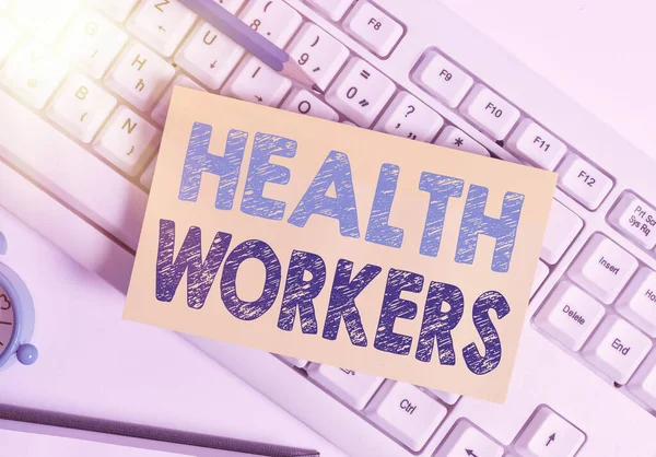 Writing note showing Health Workers. Business photo showcasing showing whose job to protect the health of their communities White pc keyboard note paper and paper clips above white background.