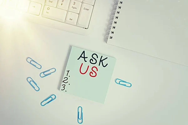Text sign showing Ask Us. Conceptual photo accepting questions or inquiry from showing Will answers any doubts Empty note paper on the white background by the pc keyboard with copy space.