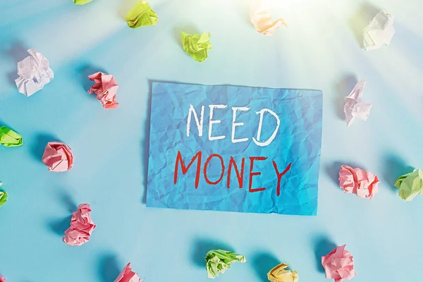 Writing note showing Need Money. Business photo showcasing require a financial assistance to sustain spending or endeavor Colored crumpled rectangle shaped reminder paper light blue background.