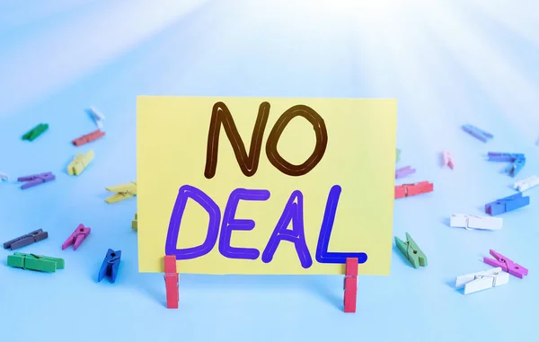 Conceptual hand writing showing No Deal. Business photo text a negative result on agreement or an arrangement like in business Colored clothespin rectangle shaped paper blue background.