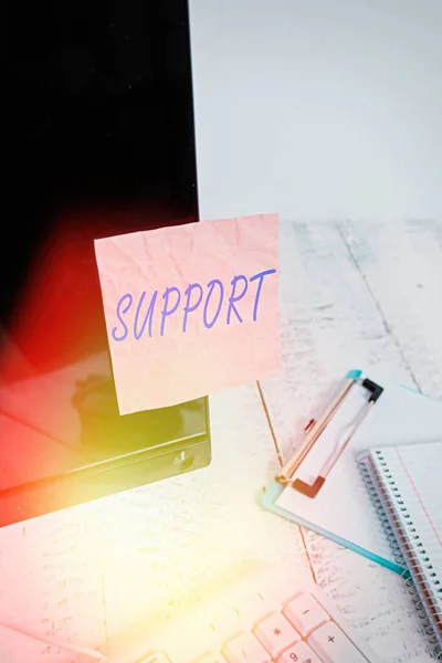 Text sign showing Support. Conceptual photo maintain, sustain, uphold all mean to hold up and to preserve Note paper taped to black computer screen near keyboard and stationary. — Stock Photo, Image