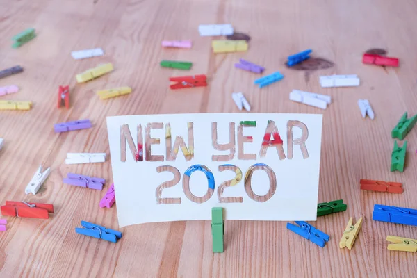 Text sign showing New Year 2020. Conceptual photo Greeting Celebrating Holiday Fresh Start Best wishes Colored clothespin papers empty reminder wooden floor background office. — Stock Photo, Image