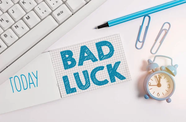 Writing note showing Bad Luck. Business photo showcasing an unfortunate state resulting from unfavorable outcomes Mischance White pc keyboard with paper and paper clip above white background.