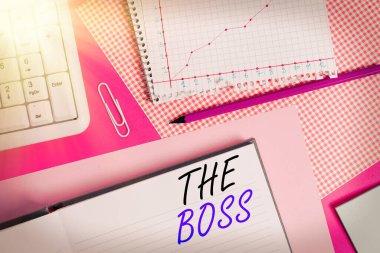 Patronu gösteren kavramsal el yazısı. İş fotoğraflarında, organizasyonda kimin denetim veya otorite sahibi olduğunu gösteren açık tablolara yerleştirilmiş yazma ekipmanları ve bilgisayar malzemeleri..