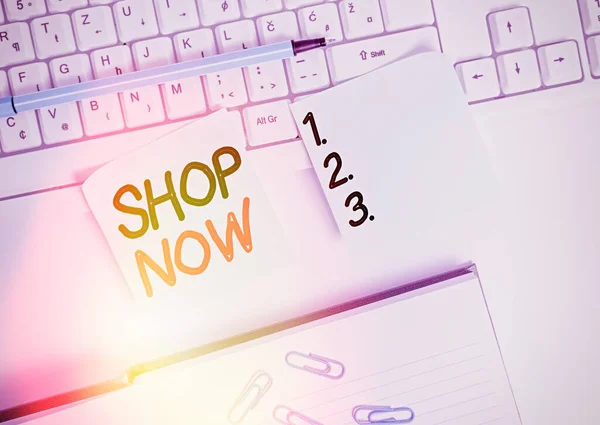 Word writing text Shop Now. Business concept for the action or activity of purchasing goods from stores or online Flat lay above blank copy space sticky notes with business concept.