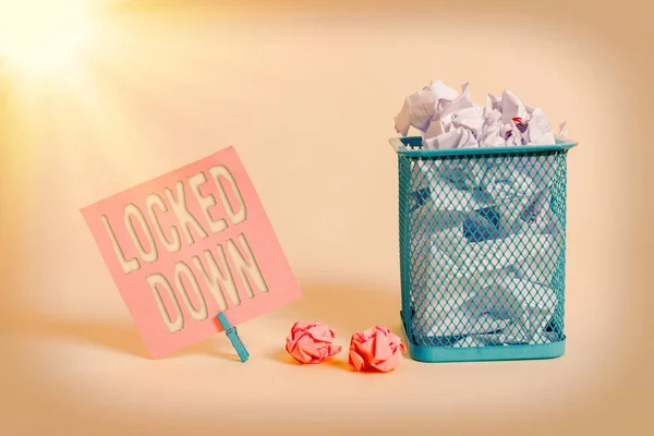 Writing note showing Locked Down. Business photo showcasing emergency measure which showing prevented from restricted area Note paper and stationary placed above soft pastel colour backdrop.