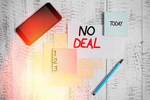 Word writing text No Deal. Business concept for a negative result on agreement or an arrangement like in business Envelopes marker ruled paper smartphone sheet note pads wooden background.