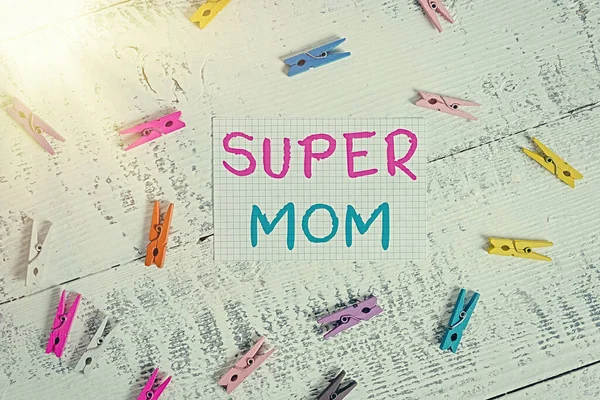 Text sign showing Super Mom. Conceptual photo a mother who can combine childcare and fulltime employment Colored clothespin rectangle square shaped paper white wood background.