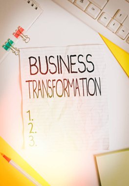 Writing note showing Business Transformation. Business photo showcasing Align their Trade models with Strategy Improvement Colored paper different sizes binder clip sheets white desk empty space. clipart
