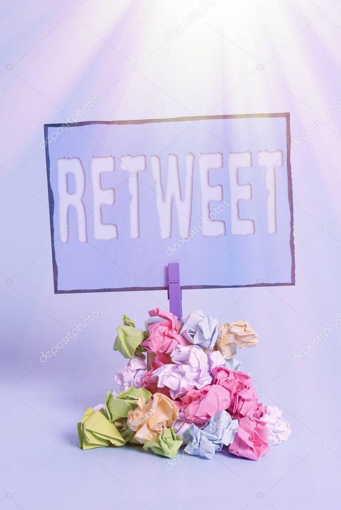 Writing note showing Retweet. Business photo showcasing in twitter repost or forward a message posted by another user Reminder pile colored crumpled paper clothespin wooden space.