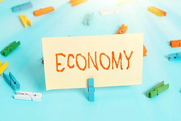 Conceptual hand writing showing Economy. Business photo showcasing Management of financial resources Accounting information analysis Colored clothespin paper empty reminder blue floor officepin. — Stock Photo, Image
