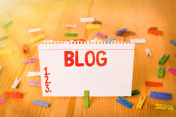 Conceptual hand writing showing Blog. Business photo showcasing regularly updated website web page run by individual Colored crumpled papers wooden floor background clothespin.