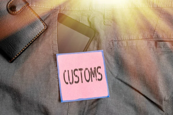 Conceptual hand writing showing Customs. Business photo showcasing Official department administers collects duties on imported goods Smartphone device inside trousers front pocket with wallet.