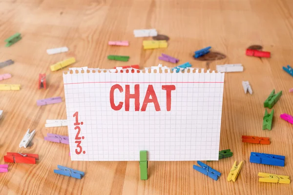 Conceptual hand writing showing Chat. Business photo showcasing take part in a discussion that involves sending messages over internet Colored crumpled papers wooden floor background clothespin. — Stock Photo, Image